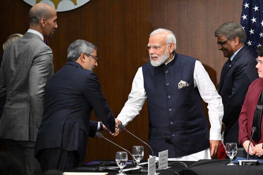 India's Prime Minister Narendra Modi shakes hands with Micron Technology CEO Sanjay Mehrotra during a visit to the National Science Foundation in Alexandria, Virginia, on June 21, 2023. (Photo by Mandel NGAN / AFP).