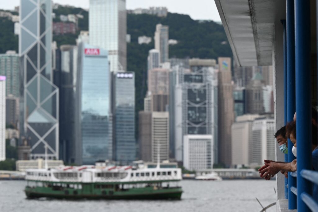 People watch a Star Ferry leave the pier in Hong Kong on July 6, 2021 as Chief Executive Carrie Lam brushed off a warning by major tech companies including Google, Facebook and Twitter that they may quit the financial hub if authorities push ahead with a new privacy law. (Photo by Peter PARKS / AFP)