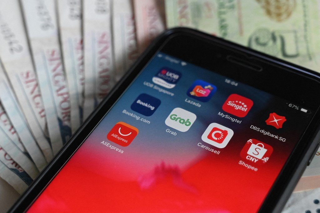 The APAC region has seen a massive jump in downloads of fintech apps, showing strong support for fintech to grow in the region. (Photo by Roslan RAHMAN / AFP)